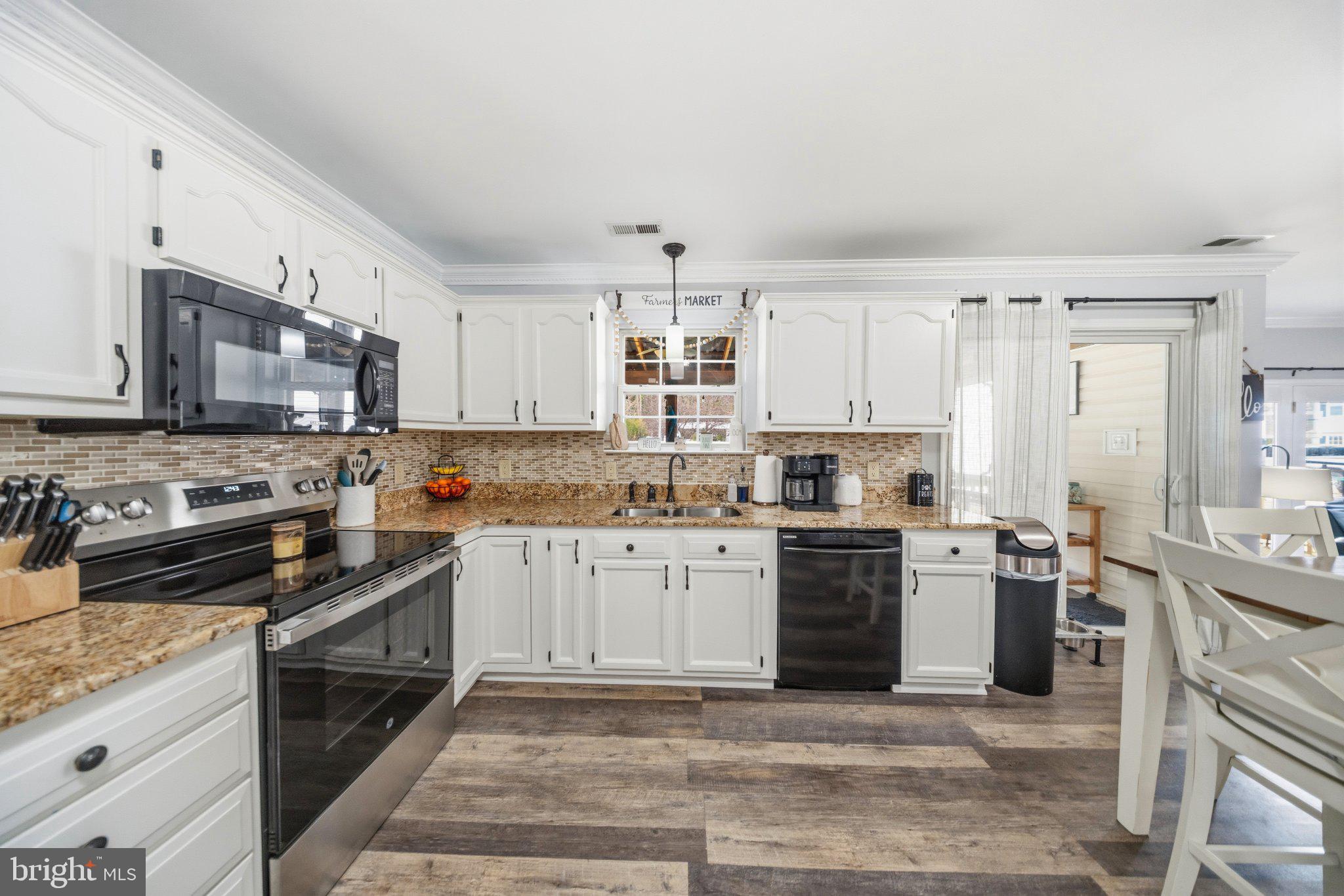 1221 Cedar Lane Edgewater, MD 21037 - Photo 15 of 58 a kitchen with stainless steel appliances granite countertop a stove top oven a sink dishwasher and a refrigerator