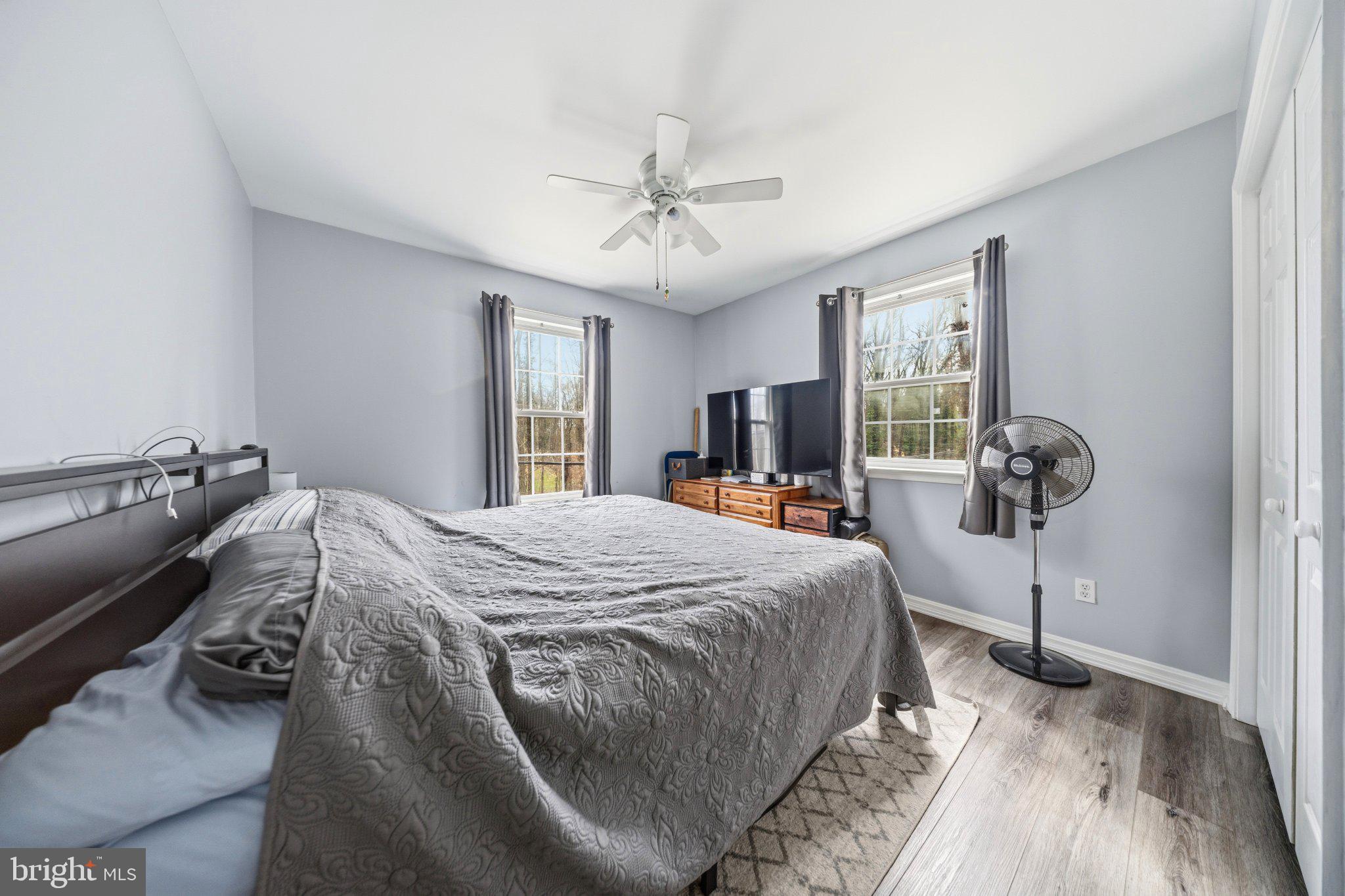 1221 Cedar Lane Edgewater, MD 21037 - Photo 29 of 58 a bed sitting in a spacious bedroom next to a window and a chandelier