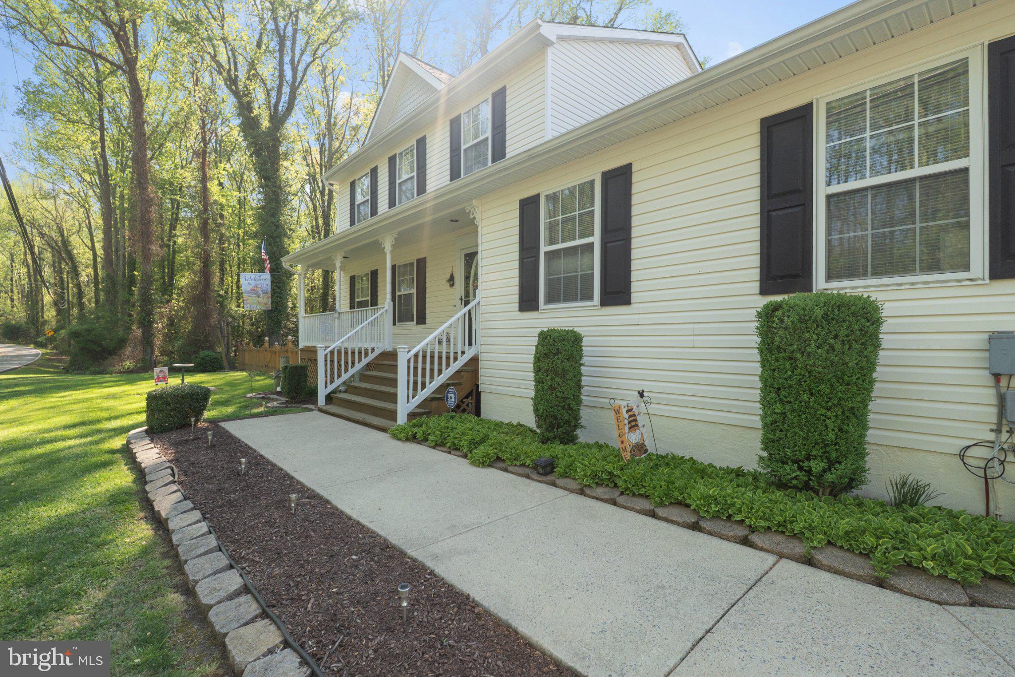 1221 Cedar Lane Edgewater, MD 21037 - Photo 3 of 58 a front view of a house with garden