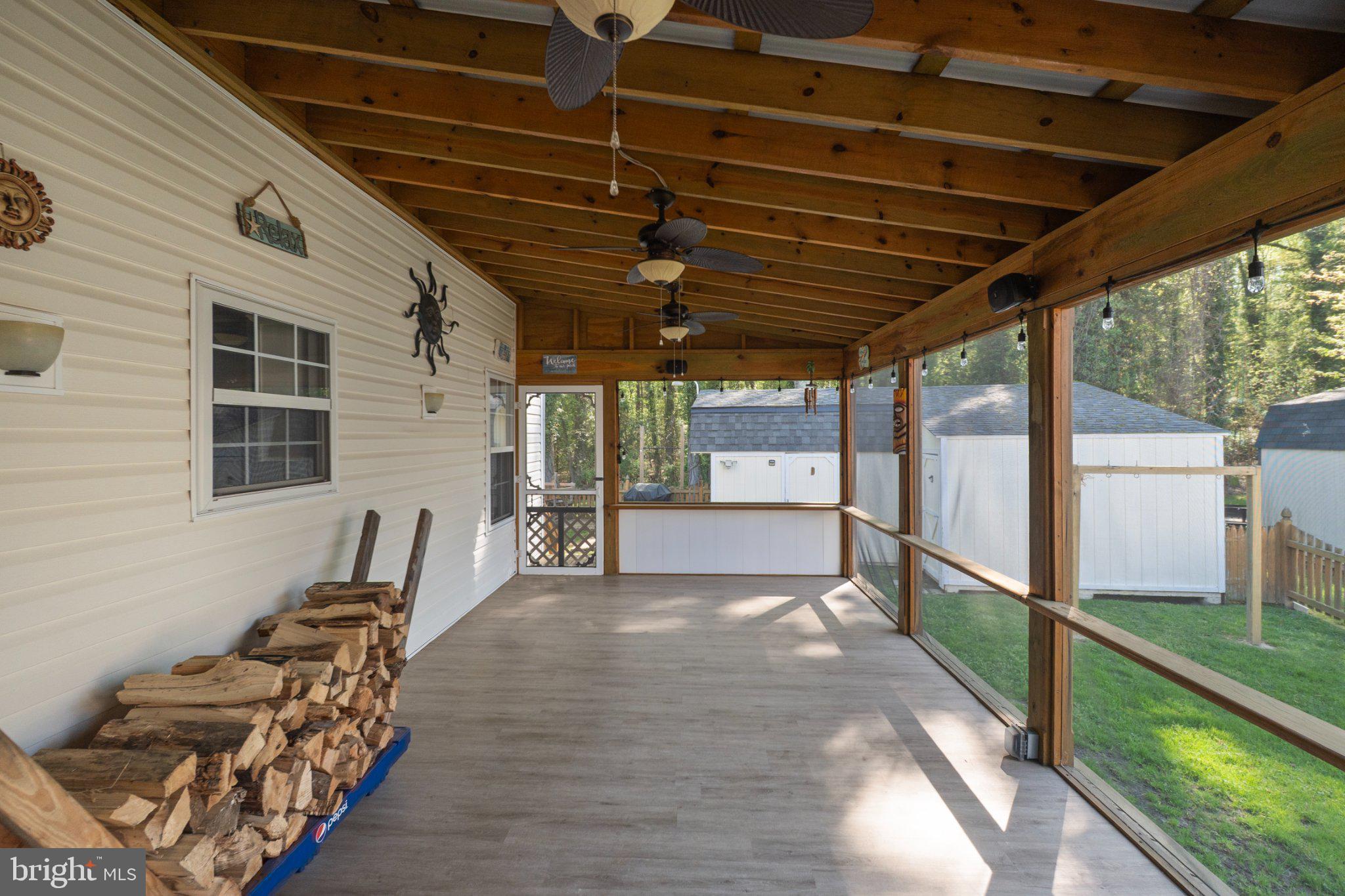 1221 Cedar Lane Edgewater, MD 21037 - Photo 37 of 58 a view of a porch with furniture and a yard