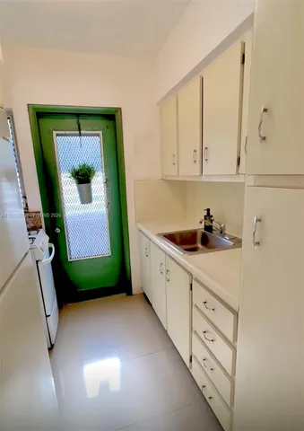 a kitchen with cabinets a sink and a window