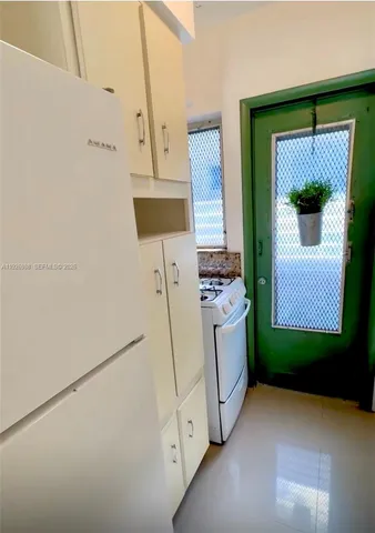 a kitchen with a refrigerator and a stove