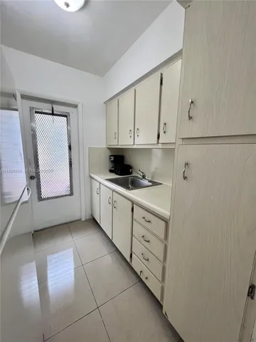 a kitchen with cabinets and window