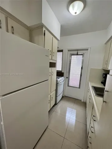 a utility room with cabinets washer and dryer