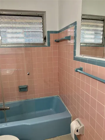 a bathroom with a shower and a bathtub