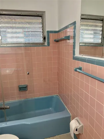 a bathroom with a shower and a bathtub