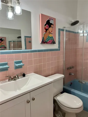 a bathroom with a sink a mirror and a toilet