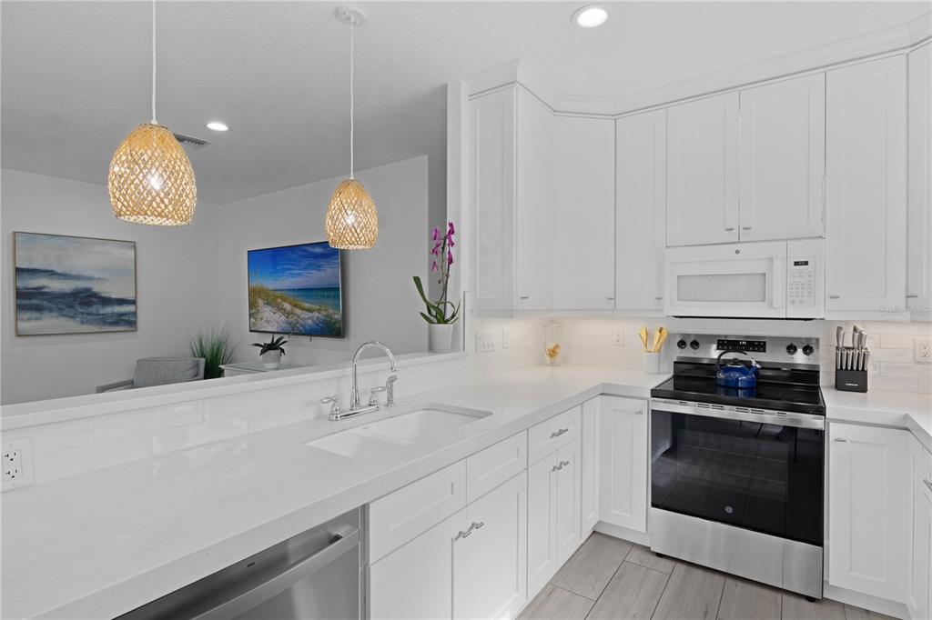 307 Spring Avenue Anna Maria, FL 34216 - Photo 13 of 51 a kitchen with cabinets and appliances