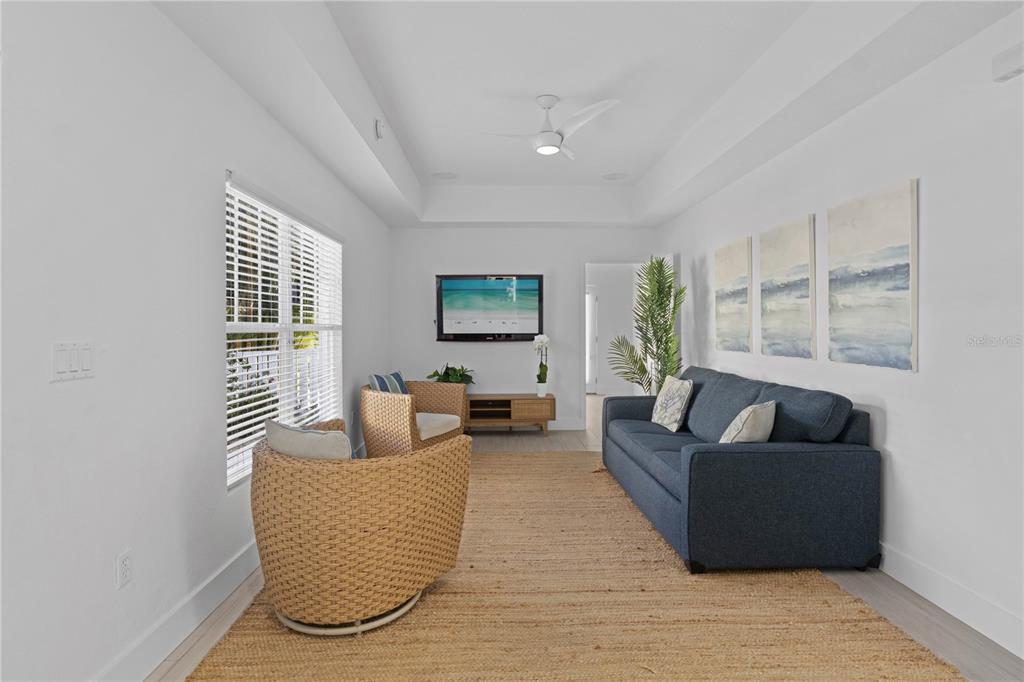 307 Spring Avenue Anna Maria, FL 34216 - Photo 16 of 51 a living room with furniture and a potted plant