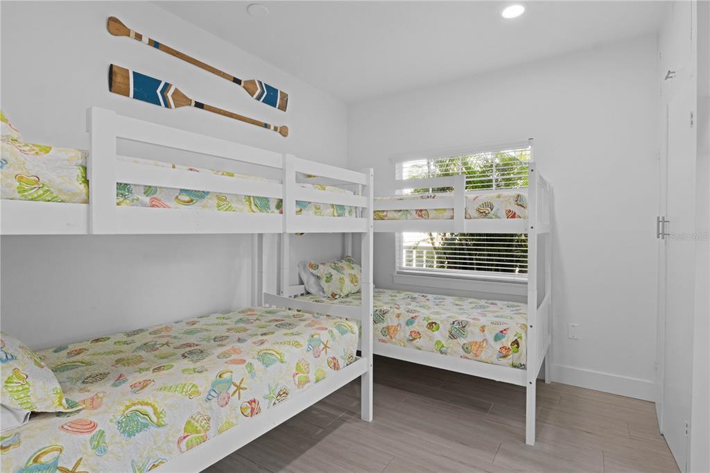 307 Spring Avenue Anna Maria, FL 34216 - Photo 21 of 51 a bedroom with a bed and a window