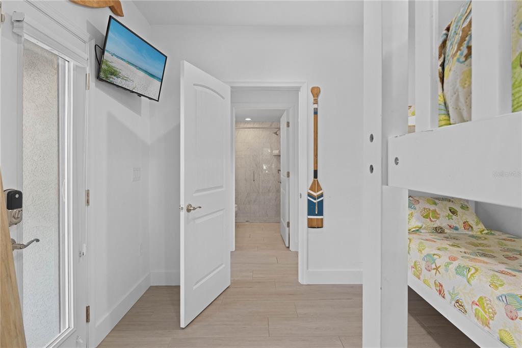 307 Spring Avenue Anna Maria, FL 34216 - Photo 23 of 51 a view of a hallway with wooden floor and a bathroom