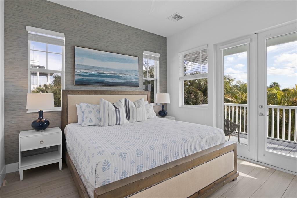 307 Spring Avenue Anna Maria, FL 34216 - Photo 26 of 51 a bedroom with a large bed and a window