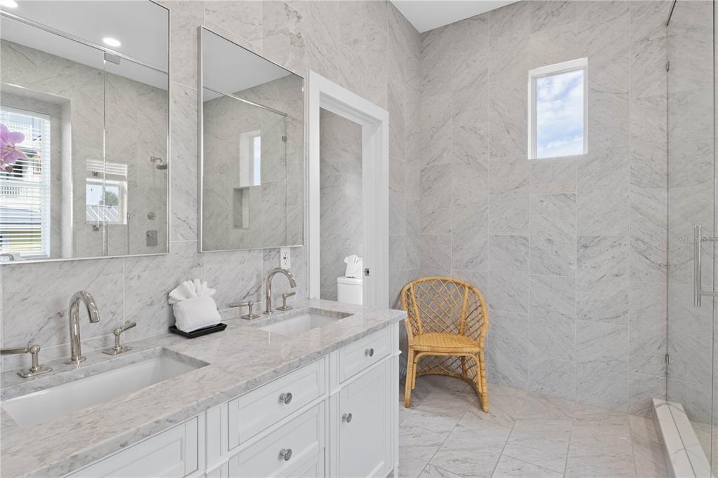 307 Spring Avenue Anna Maria, FL 34216 - Photo 30 of 51 a bathroom with a granite countertop sink and a mirror