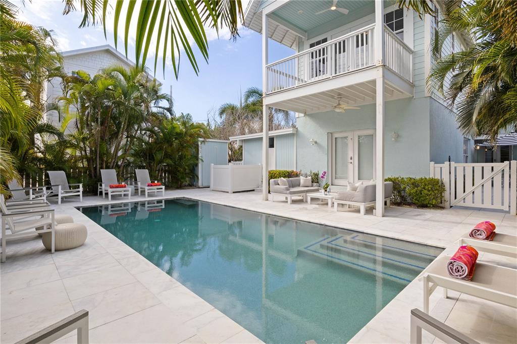 307 Spring Avenue Anna Maria, FL 34216 - Photo 3 of 51 a view of a patio with swimming pool table and chairs
