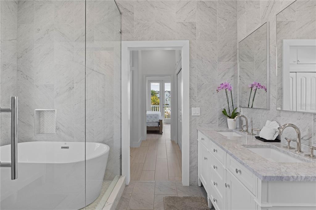 307 Spring Avenue Anna Maria, FL 34216 - Photo 32 of 51 a bathroom with a tub sink and mirror