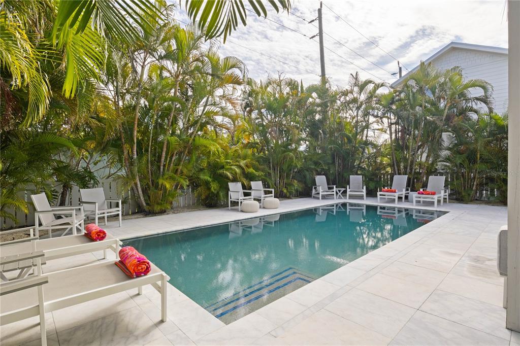 307 Spring Avenue Anna Maria, FL 34216 - Photo 39 of 51 a view of swimming pool with chairs and fire pit