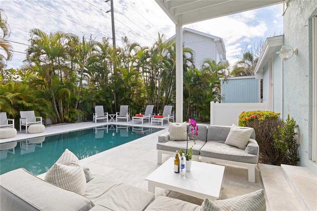 307 Spring Avenue Anna Maria, FL 34216 - Photo 40 of 51 a view of a patio with couches and a table and chairs with garden view