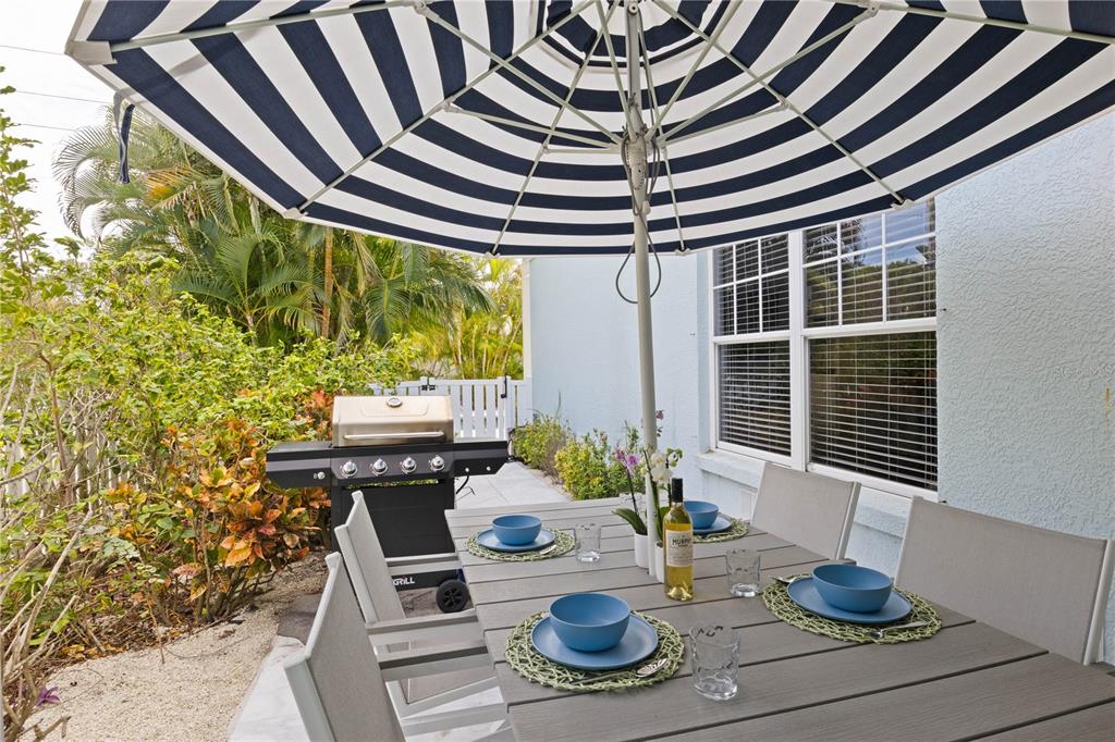 307 Spring Avenue Anna Maria, FL 34216 - Photo 43 of 51 a dining room with furniture and wooden floor