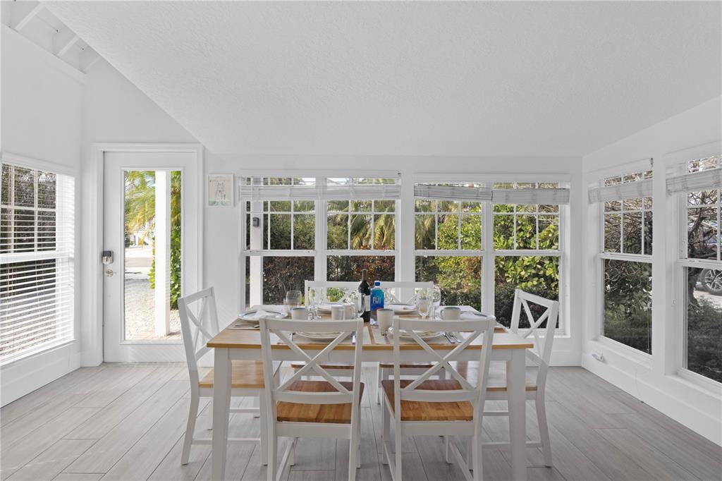 307 Spring Avenue Anna Maria, FL 34216 - Photo 5 of 51 a view of a dining room with furniture window and wooden floor