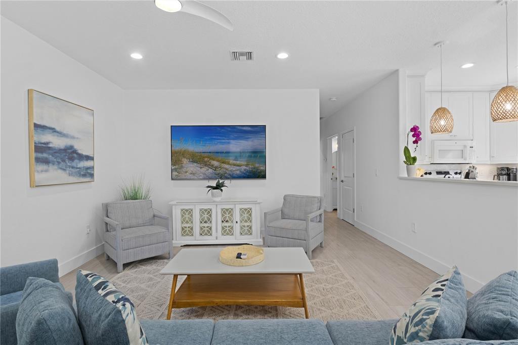 307 Spring Avenue Anna Maria, FL 34216 - Photo 7 of 51 a living room with furniture and a flat screen tv