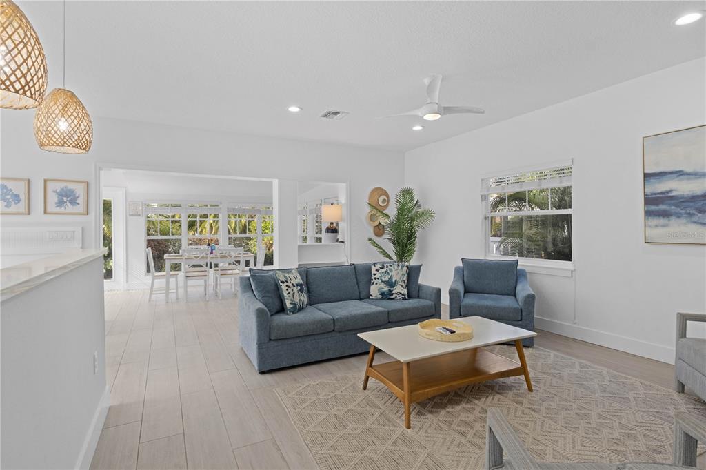 307 Spring Avenue Anna Maria, FL 34216 - Photo 9 of 51 a living room with furniture and a large window