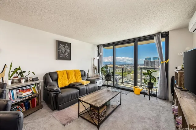 a living room with furniture and a floor to ceiling window