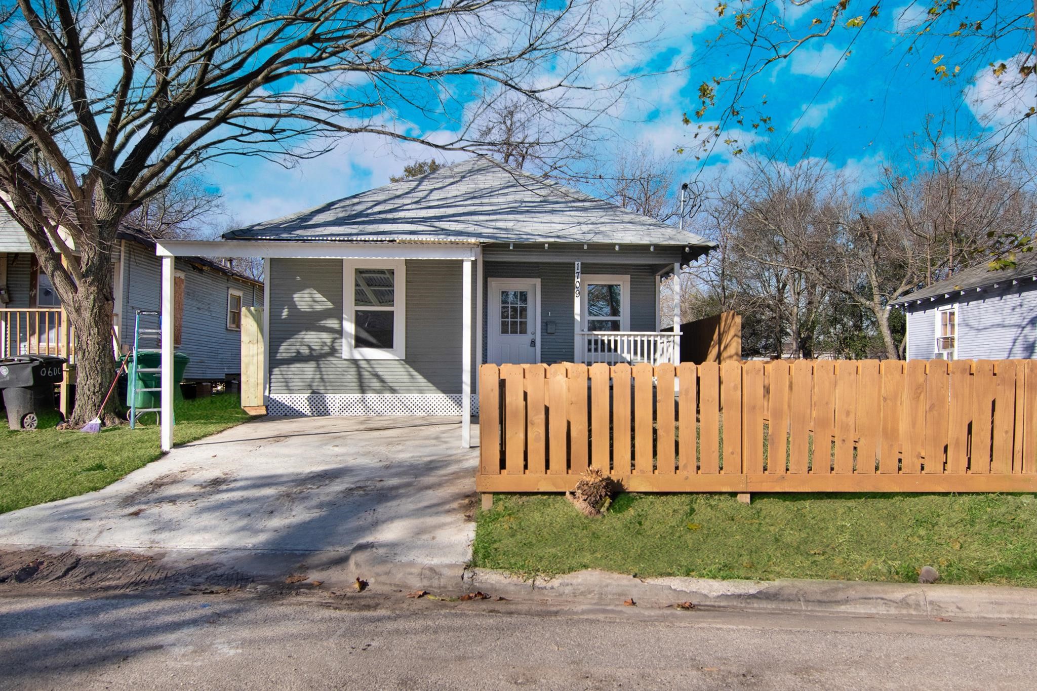 a view of a house with a yard and tree s