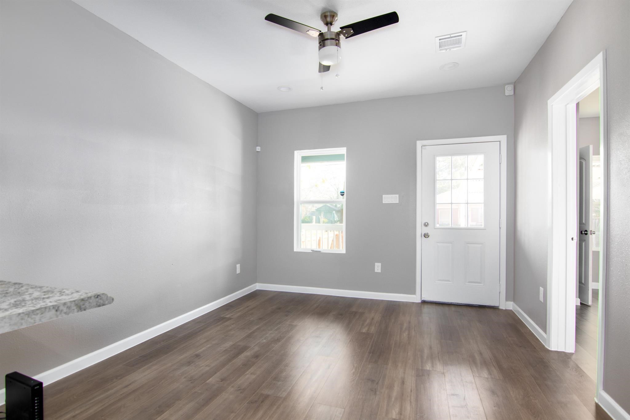 1709 Stevens Street Houston, TX 77026 - Photo 7 of 17 an empty room with wooden floor and windows