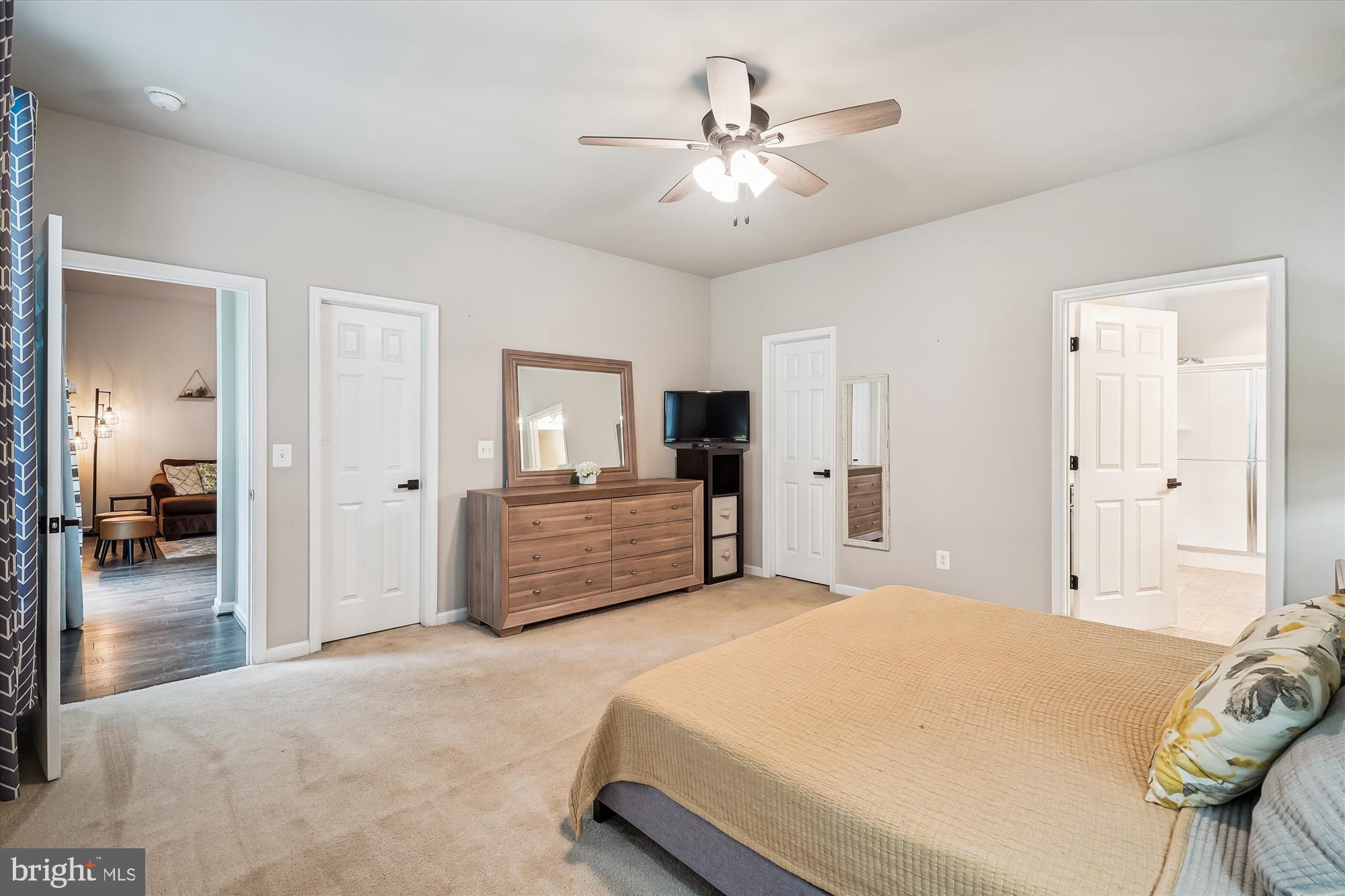 12141 Aster Road Bristow, VA 20136 - Photo 22 of 65 a spacious bedroom with a large bed and a chandelier
