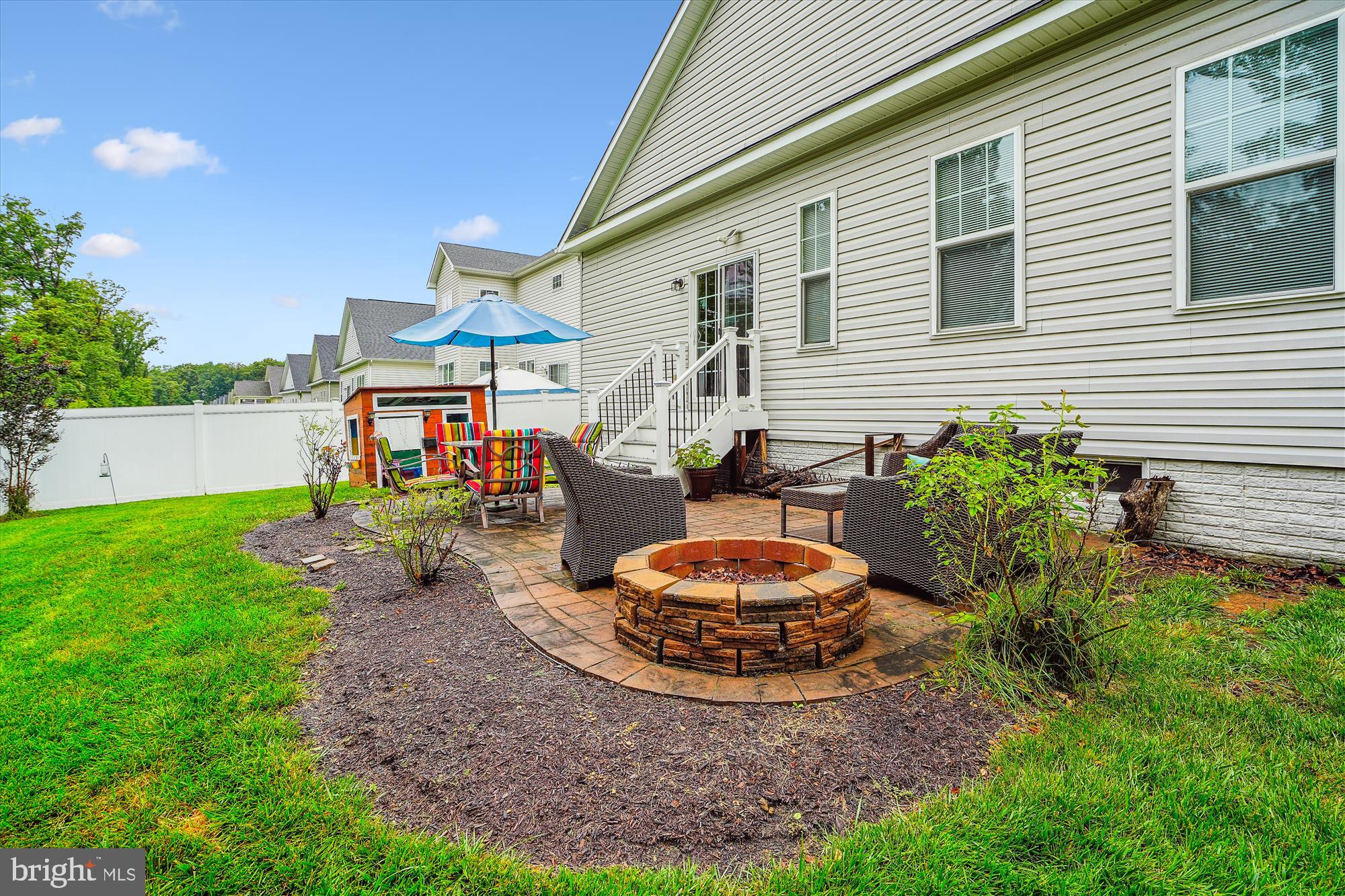 12141 Aster Road Bristow, VA 20136 - Photo 28 of 65 a table and chairs in front of a house