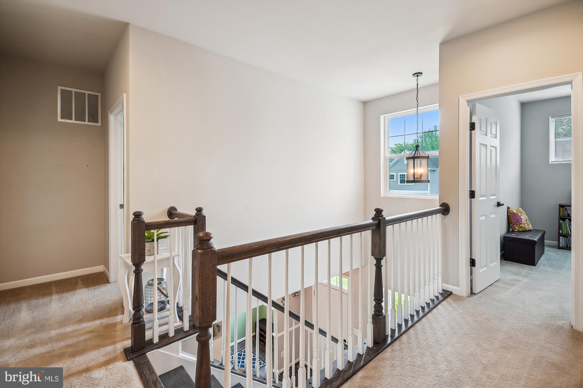 12141 Aster Road Bristow, VA 20136 - Photo 32 of 65 a view of a hallway with wooden floor and stairs