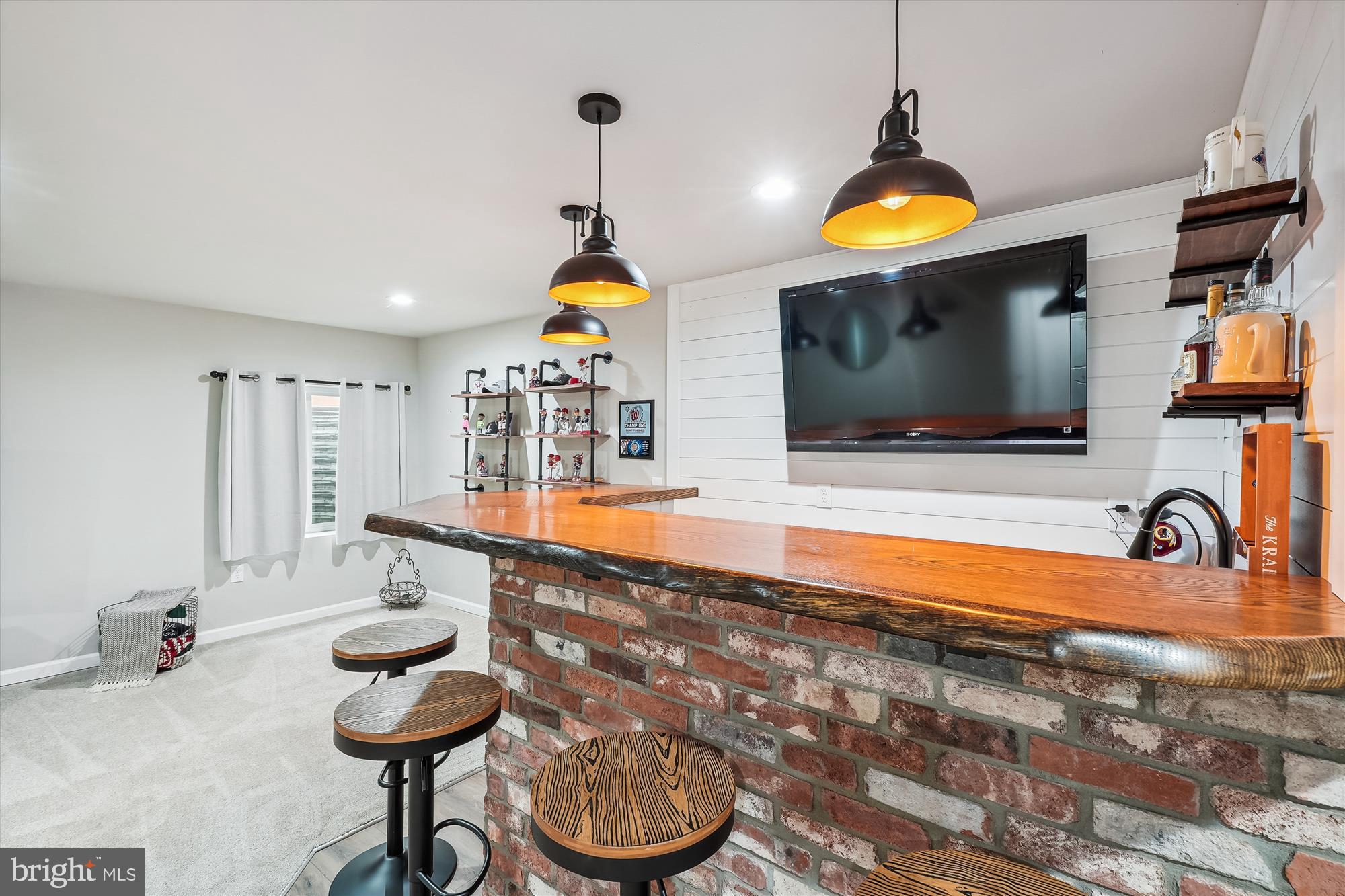 12141 Aster Road Bristow, VA 20136 - Photo 46 of 65 a kitchen with stainless steel appliances a sink and a flat screen tv