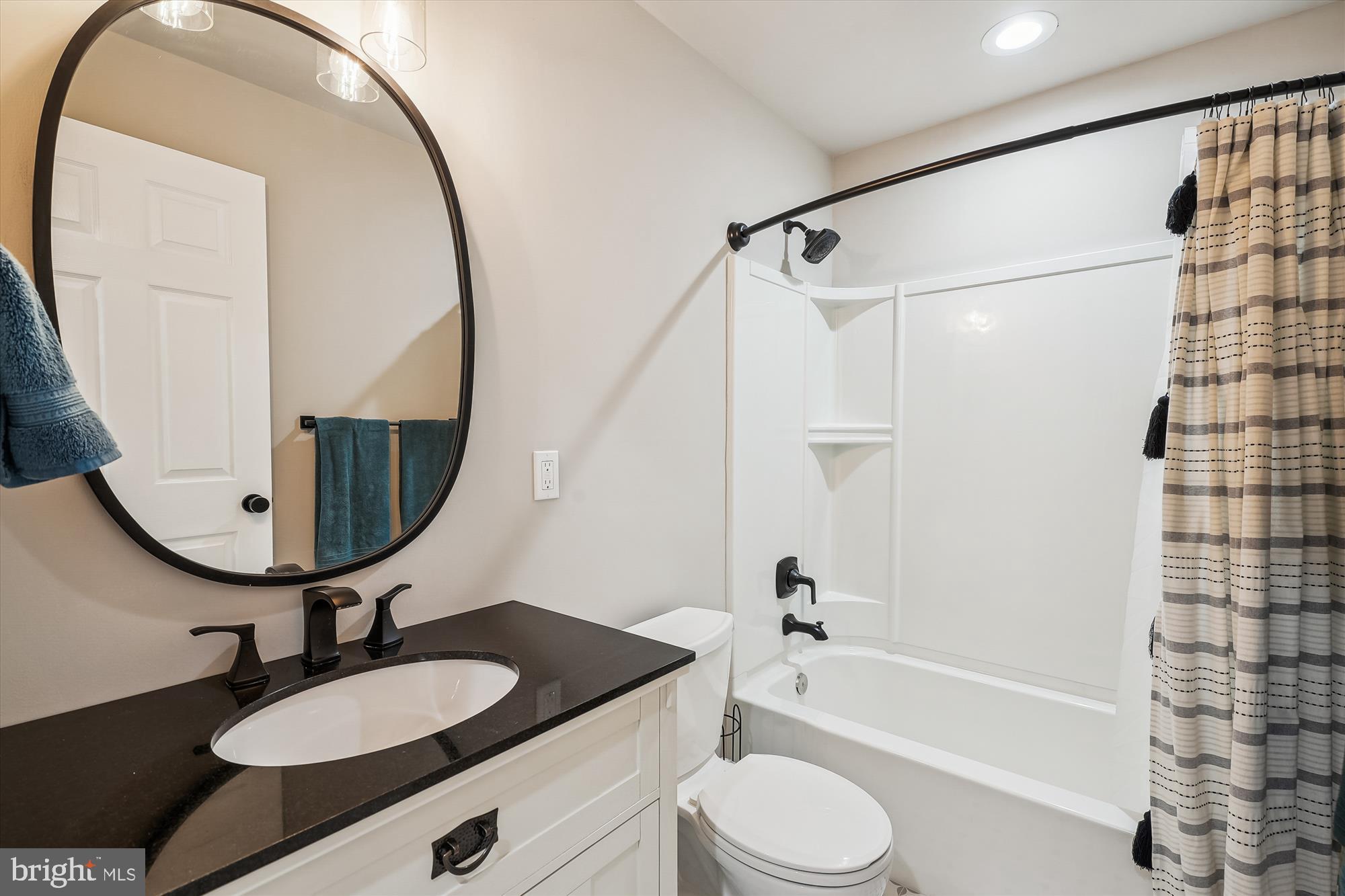12141 Aster Road Bristow, VA 20136 - Photo 49 of 65 a bathroom with a sink a toilet and a mirror