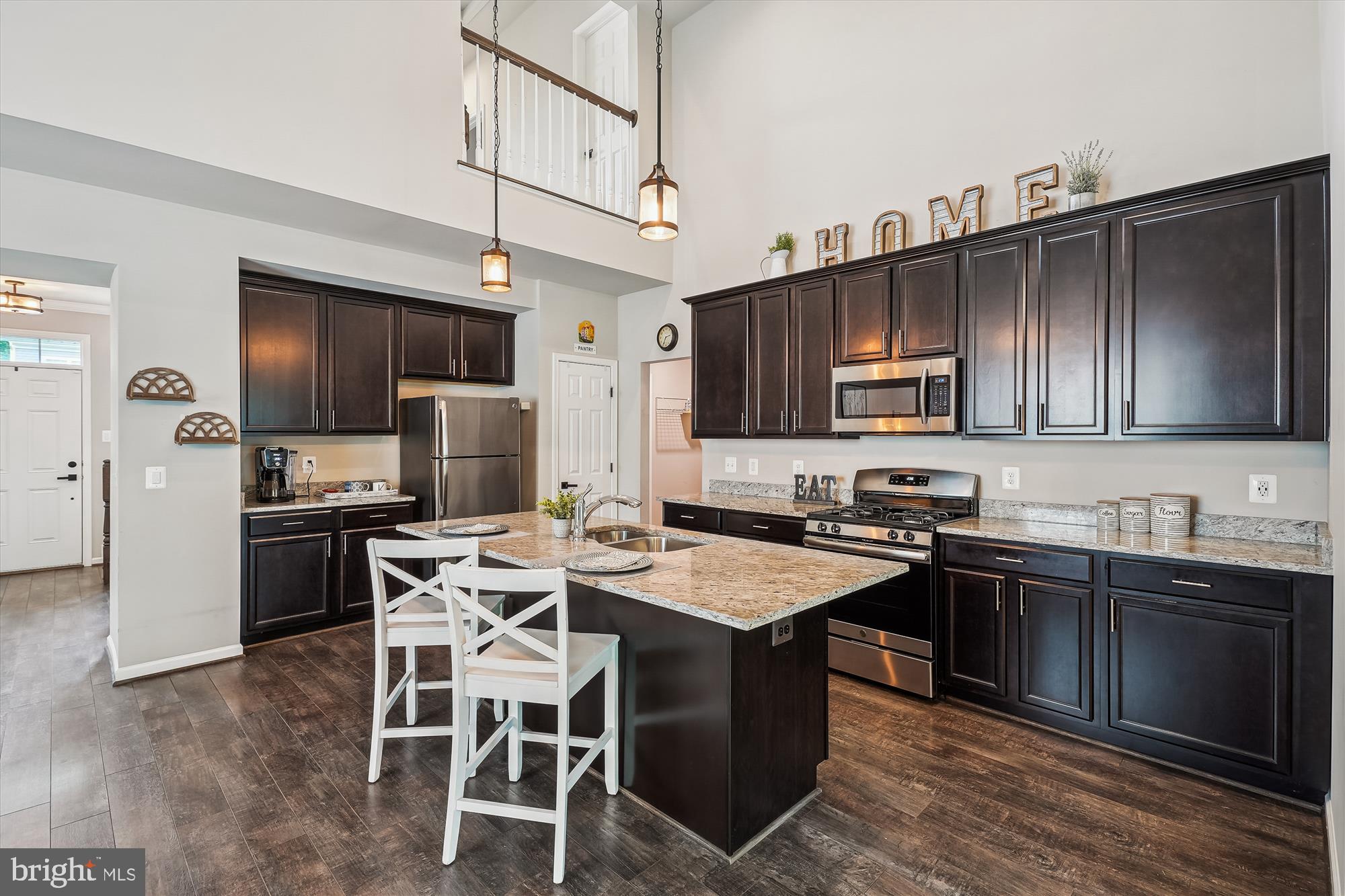 12141 Aster Road Bristow, VA 20136 - Photo 10 of 65 a kitchen with stainless steel appliances granite countertop a sink dishwasher a stove refrigerator a microwave oven with granite countertops and cabinets