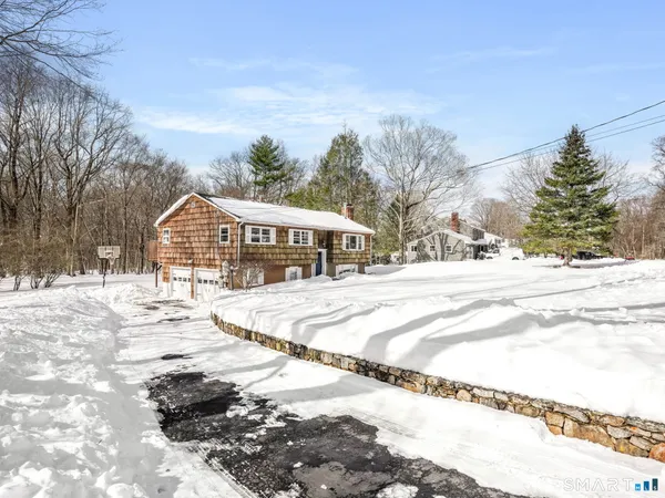 a view of houses with snow on the road