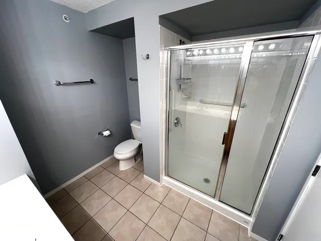 a view of a hallway with wooden floor and stairs