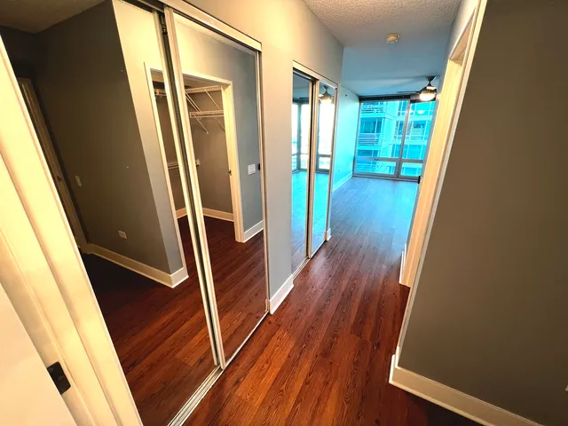 a view of a room with wooden floor