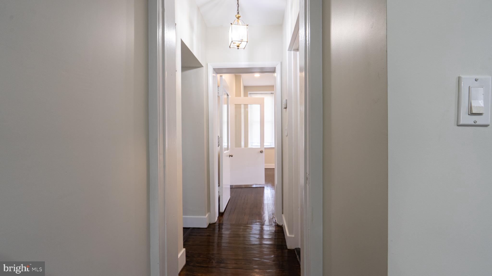 317 East Patapsco Avenue Baltimore, MD 21225 - Photo 19 of 36 Inviting hallway with natural light glow.