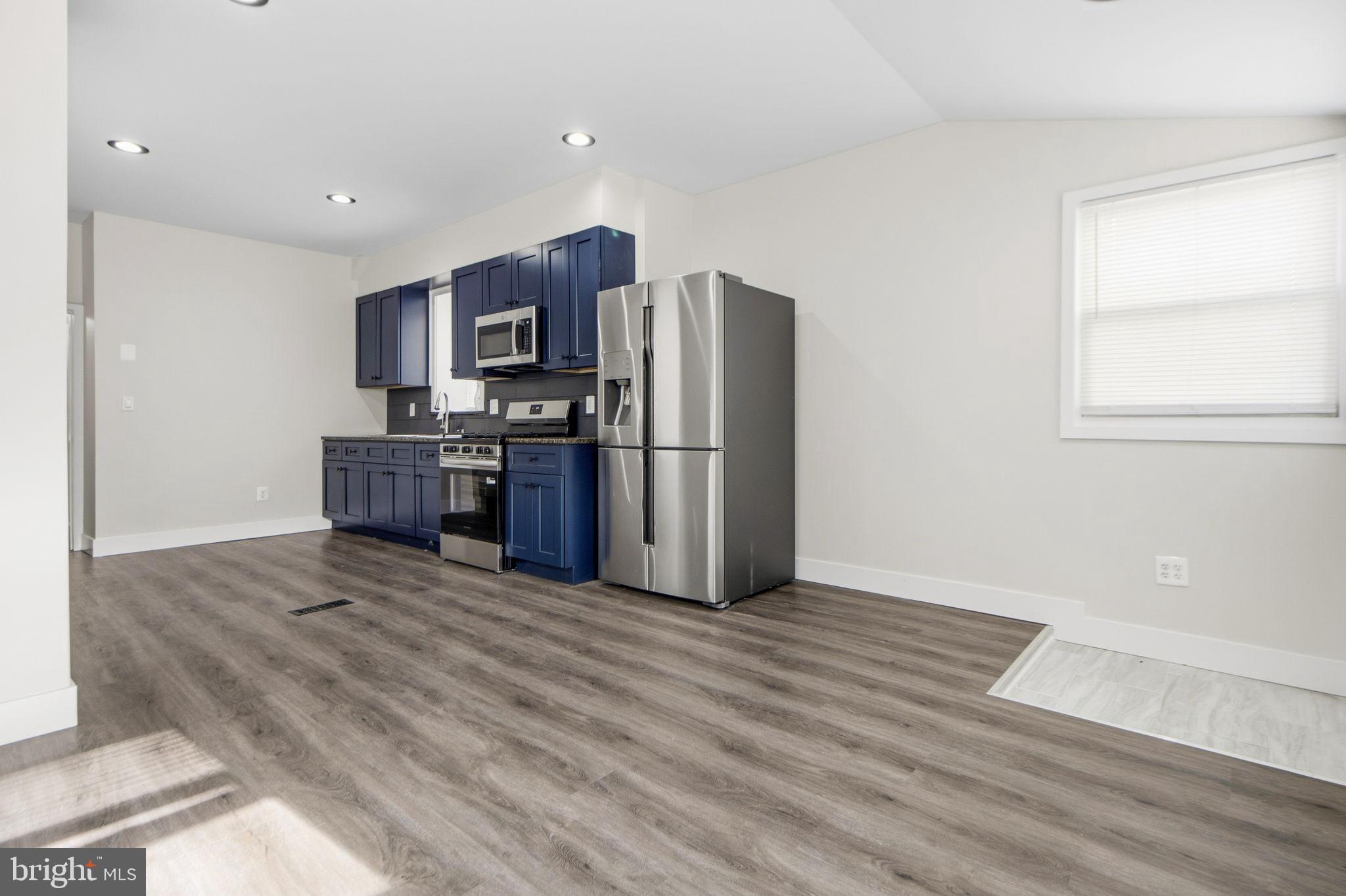 317 East Patapsco Avenue Baltimore, MD 21225 - Photo 26 of 36 Modern kitchen with sleek blue cabinetry.