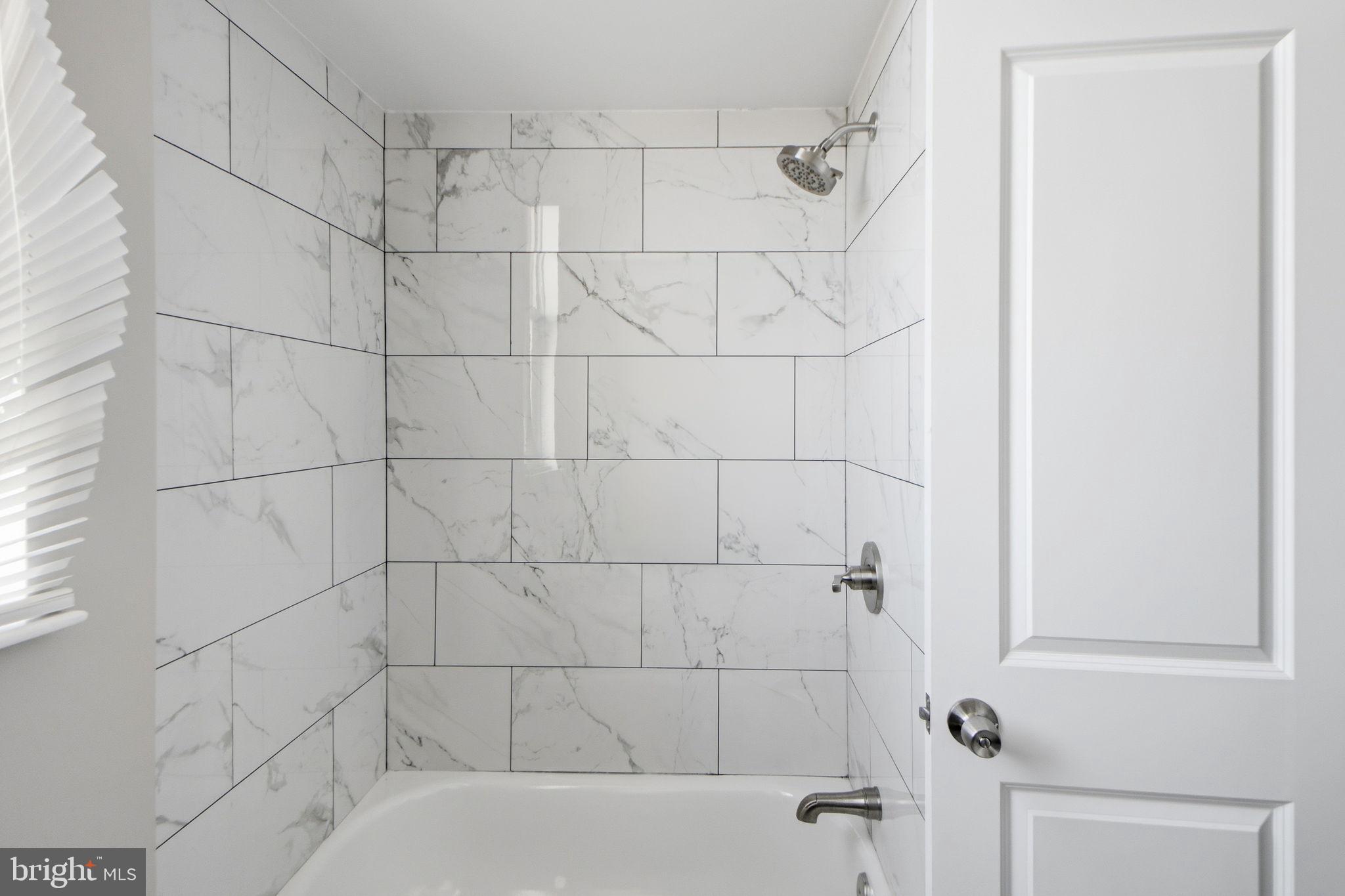 317 East Patapsco Avenue Baltimore, MD 21225 - Photo 35 of 36 Elegant-tiled shower retreat.