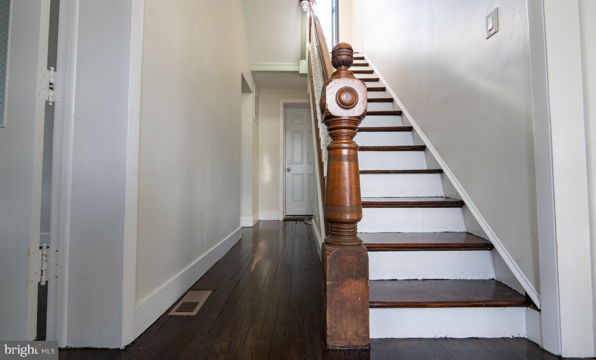 317 East Patapsco Avenue Baltimore, MD 21225 - Photo 10 of 36 Inviting hallway with classic staircase charm.