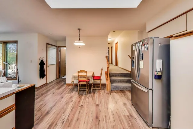 a kitchen with stainless steel appliances a refrigerator and wooden floor