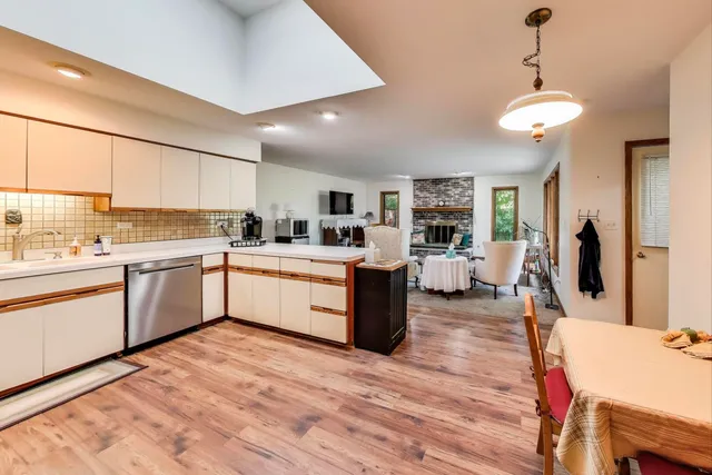 a kitchen with a sink window and cabinets