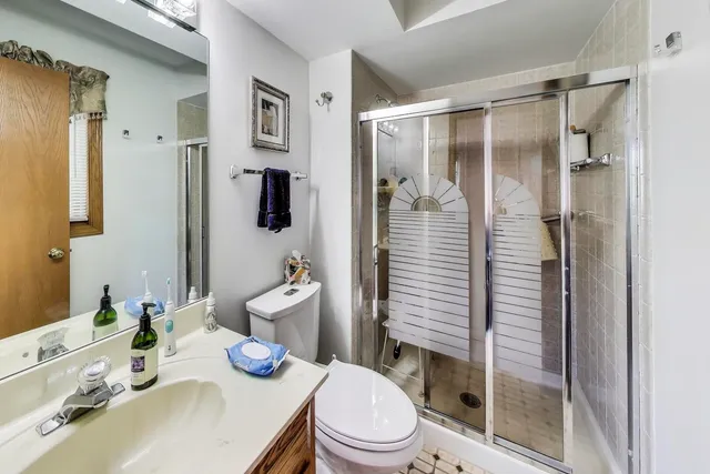 a bathroom with a sink toilet and shower