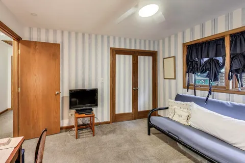 a living room with furniture a rug and a flat screen tv