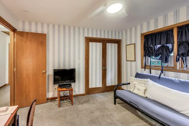 a living room with furniture a rug and a flat screen tv