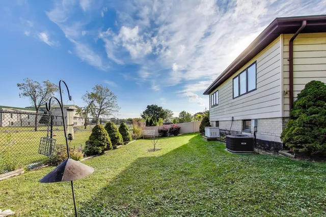 a view of a house with backyard and sitting area