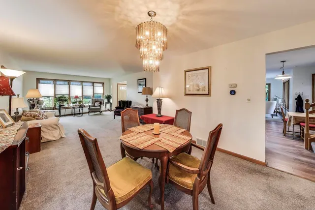 a view of a dining room with furniture and a chandelier