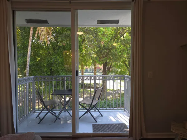 a view of a porch with chairs and backyard