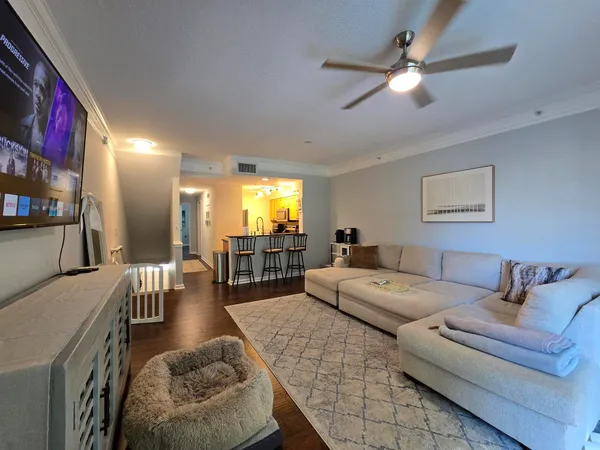 a living room with furniture and a chandelier